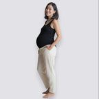 Celviroa black ribbed tank top and cream lounge pants on a smiling pregnant woman. Comfortable, breathable, and supportive.
