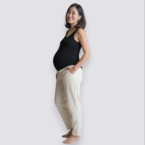 Celviroa black ribbed tank top and cream lounge pants on a smiling pregnant woman. Comfortable, breathable, and supportive.